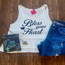 Load image into Gallery viewer, White tank top with 'Bless your Heart' text, blue shorts, and a blue cross pendant on a wooden surface.