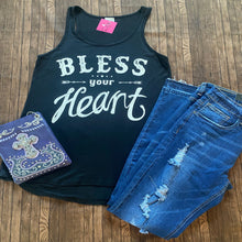 Load image into Gallery viewer, Black tank top with 'Bless your Heart' text, blue denim shorts, and a blue cross purse on a wooden surface.